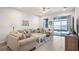 Comfortable living room with sliding glass doors to a screened lanai with water views at 3256 Canna Lily Pl, Clermont, FL 34711