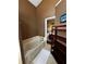 Bathroom featuring a soaking tub, shelving and tiled floor at 3511 Fox Lake Dr, Apopka, FL 32712