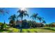 Lovely home exterior with palm trees, luscious green lawn, and sunny blue skies at 3511 Fox Lake Dr, Apopka, FL 32712