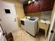 Functional laundry room with washer, dryer, sink, cabinets and exterior door at 3511 Fox Lake Dr, Apopka, FL 32712