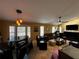 Open-concept living room with ceiling fan, fireplace, and large windows at 3511 Fox Lake Dr, Apopka, FL 32712