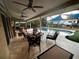Covered outdoor patio with dining area, fire pit, bar, BBQ and pool at 3511 Fox Lake Dr, Apopka, FL 32712