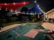 A beautiful swimming pool with colorful shade sails and ambient lighting at 3511 Fox Lake Dr, Apopka, FL 32712