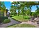 Beautiful backyard with lush landscaping, brick patio, and comfortable seating at 39705 Grove Hts, Lady Lake, FL 32159