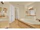 Elegant bathroom features a soaking tub, double sinks, and tile floors at 39705 Grove Hts, Lady Lake, FL 32159
