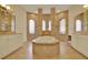 Luxurious bathroom with soaking tub, dual vanities, and tile flooring at 39705 Grove Hts, Lady Lake, FL 32159