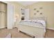 Cozy bedroom with a closet, a ceiling fan, a bed, and carpeted floors, filled with sunlight at 39705 Grove Hts, Lady Lake, FL 32159