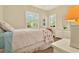 Bright bedroom with shuttered windows, a ceiling fan, a bed, and white painted furnishings at 39705 Grove Hts, Lady Lake, FL 32159