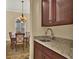 The dining room has a granite-topped wet bar and an elegant light fixture at 39705 Grove Hts, Lady Lake, FL 32159