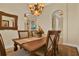 Elegant dining room featuring a wooden table, chandelier, and arched doorway at 39705 Grove Hts, Lady Lake, FL 32159