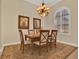Traditional dining room with a wooden table, upholstered chairs, and a shuttered window at 39705 Grove Hts, Lady Lake, FL 32159