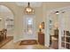Elegant foyer with a decorative front door, neutral walls, and views of the dining and living areas at 39705 Grove Hts, Lady Lake, FL 32159