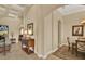 Neutral hallway with a coffered ceiling and connections to the living and dining areas at 39705 Grove Hts, Lady Lake, FL 32159