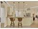 Bright kitchen bar area with granite countertops, pendant lights, and stainless steel appliances at 39705 Grove Hts, Lady Lake, FL 32159
