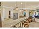 Open kitchen bar area with granite countertops, stainless steel appliances, and casual seating at 39705 Grove Hts, Lady Lake, FL 32159