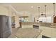 Well-lit kitchen features granite countertops, stainless steel appliances, and tile flooring at 39705 Grove Hts, Lady Lake, FL 32159