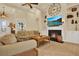 Inviting living room with fireplace, coffered ceiling and built-in shelving at 39705 Grove Hts, Lady Lake, FL 32159