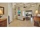 Spacious living room with a fireplace, ceiling fan, and sliding glass doors leading to the outdoor patio at 39705 Grove Hts, Lady Lake, FL 32159