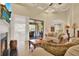 Bright living room with a fireplace, access to a patio, and a seamless flow into the kitchen at 39705 Grove Hts, Lady Lake, FL 32159