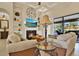 Comfortable living room with fireplace, built-in shelves, and sliding glass doors to the outdoor patio at 39705 Grove Hts, Lady Lake, FL 32159