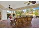 Covered patio with brick floors, ceiling fans, and comfortable seating, perfect for outdoor relaxation at 39705 Grove Hts, Lady Lake, FL 32159