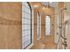 Beautiful shower with tiled walls, decorative accents, multiple showerheads, and arched windows at 39705 Grove Hts, Lady Lake, FL 32159