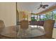 Bright sunroom with glass table, chairs, ceiling fans and exterior view at 39705 Grove Hts, Lady Lake, FL 32159
