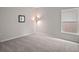 Bedroom with neutral walls, a large window, and carpet flooring providing a calm and inviting atmosphere at 444 Shadow Gorge Way, Eustis, FL 32736