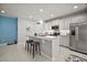 Bright kitchen with a large island, stainless steel appliances, and open access to the living area at 444 Shadow Gorge Way, Eustis, FL 32736