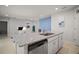 Kitchen island with granite countertops and stainless steel appliances overlooking the living space at 444 Shadow Gorge Way, Eustis, FL 32736