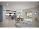Open-concept floor plan with living, dining, and kitchen area leading to an outdoor patio at 444 Shadow Gorge Way, Eustis, FL 32736