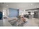Open-concept living space connects to the kitchen with a breakfast bar and modern appliances at 444 Shadow Gorge Way, Eustis, FL 32736