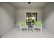 Covered patio with comfortable chairs and a table, perfect for relaxing and enjoying the outdoors at 444 Shadow Gorge Way, Eustis, FL 32736