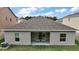 Back patio seating area features easy access via sliding glass doors that enhances indoor/outdoor living at 444 Shadow Gorge Way, Eustis, FL 32736