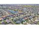 An elevated view showcases a community with lush landscaping, tranquil ponds, and perfectly aligned streets at 449 Gilson Loop, The Villages, FL 32163