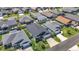 A drone shot captures a neighborhood's well-kept homes, grassy lawns, and neatly paved streets in a sunny setting at 449 Gilson Loop, The Villages, FL 32163