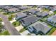An aerial view shows beautiful single Gathering homes in a well-maintained neighborhood with green lawns at 449 Gilson Loop, The Villages, FL 32163