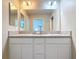 Elegant bathroom featuring double sinks, modern vanity, and a large mirror, offering a spa-like experience at 449 Gilson Loop, The Villages, FL 32163