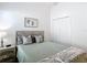 Cozy bedroom with a comfortable bed, soft lighting, and minimalist decor at 449 Gilson Loop, The Villages, FL 32163