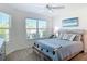 Inviting bedroom with a large window, modern coastal art, and stylish driftwood-style accents at 449 Gilson Loop, The Villages, FL 32163
