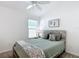 Serene bedroom featuring a comfortable bed, ample natural light, and minimalist decorations at 449 Gilson Loop, The Villages, FL 32163