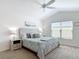 Bright bedroom featuring a ceiling fan, large window, and coordinated furniture for a cozy, inviting atmosphere at 449 Gilson Loop, The Villages, FL 32163