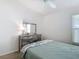 Bright bedroom with a ceiling fan, large dresser with mirror, and a serene space for relaxation and rest at 449 Gilson Loop, The Villages, FL 32163