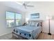 Bright, sunlit bedroom with view, fan and modern coastal decor; ideal for a peaceful retreat at 449 Gilson Loop, The Villages, FL 32163