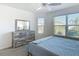 Bright bedroom with large windows, a driftwood-style dresser, and calming natural light for a restful space at 449 Gilson Loop, The Villages, FL 32163