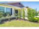 Welcoming front entrance with stylish siding, manicured shrubs and a covered entryway at 449 Gilson Loop, The Villages, FL 32163