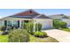 Well-kept single-story home with a two-car garage and lush green lawn at 449 Gilson Loop, The Villages, FL 32163