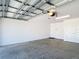 Clean, spacious garage with white walls, ample lighting and storage, and a concrete floor at 449 Gilson Loop, The Villages, FL 32163