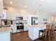 Well-lit kitchen with stainless steel appliances, granite countertops, and breakfast bar seating at 449 Gilson Loop, The Villages, FL 32163