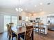 Bright and airy kitchen with stainless steel appliances, white cabinets, and sliding glass doors to the backyard at 449 Gilson Loop, The Villages, FL 32163